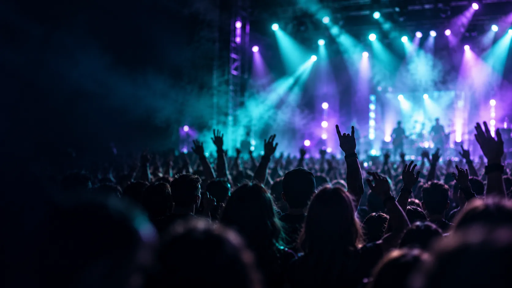 Live concert crowd at a music festival with stage lights